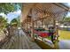 Red fishing boat on a covered lift; wooden dock and canal view at 34205 Island Dr, Leesburg, FL 34788