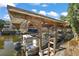 Covered boat slip with pontoon boat and waterfront access at 34205 Island Dr, Leesburg, FL 34788
