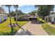 Single story home with carport and landscaped yard at 34205 Island Dr, Leesburg, FL 34788