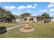 Single-story home with landscaped yard, fountain, and shed at 34205 Island Dr, Leesburg, FL 34788