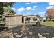 Single-story home with shed and stone path at 34205 Island Dr, Leesburg, FL 34788