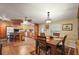 Open kitchen with island, wood cabinets, and breakfast area at 34205 Island Dr, Leesburg, FL 34788