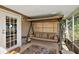 Covered porch swing and seating area in a screened enclosure at 34205 Island Dr, Leesburg, FL 34788