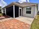 Exterior view of the backyard, showcasing the screen patio, pavers, and landscaped areas at 3554 Oracle Ct, The Villages, FL 32163