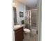 Cozy bathroom features a shower-tub combination and a single sink vanity with wooden cabinetry at 3554 Oracle Ct, The Villages, FL 32163