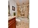 Bathroom with tiled shower/tub combo, decorative shower curtain, and stylish vanity at 3554 Oracle Ct, The Villages, FL 32163
