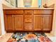 Bathroom featuring a double vanity with wood cabinets and a lovely floral rug at 3554 Oracle Ct, The Villages, FL 32163