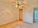 Bedroom with neutral carpet, a ceiling fan, and a closet for storage at 3554 Oracle Ct, The Villages, FL 32163