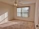 Bright bedroom with a ceiling fan, plush carpet and a large window that allows an abundance of natural light at 3554 Oracle Ct, The Villages, FL 32163