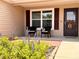 Inviting front porch with seating and colorful landscaping at 3554 Oracle Ct, The Villages, FL 32163