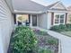 Charming home featuring landscaped front yard with pathway leading to front door at 3554 Oracle Ct, The Villages, FL 32163