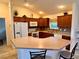 Kitchen with breakfast bar, ample cabinet space, and modern appliances at 3554 Oracle Ct, The Villages, FL 32163