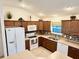 Well-lit kitchen features wood cabinets, modern appliances and neutral countertops and backsplash at 3554 Oracle Ct, The Villages, FL 32163