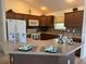 Spacious kitchen with wood cabinets and an island at 3554 Oracle Ct, The Villages, FL 32163