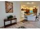 Open-concept living room flowing into a kitchen with a breakfast bar and modern appliances at 3554 Oracle Ct, The Villages, FL 32163