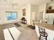 Open-concept living area with vaulted ceiling, breakfast bar, and dining area at 3554 Oracle Ct, The Villages, FL 32163