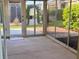 Enclosed sunroom with tile floor, large glass windows, and door to outside at 3554 Oracle Ct, The Villages, FL 32163