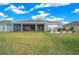 Landscaped backyard with large covered patio at 4442 Shannon Loop, The Villages, FL 32163