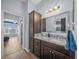 Modern bathroom with granite vanity and access to bedroom at 4442 Shannon Loop, The Villages, FL 32163