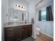 Shows bathroom with blue walls, vanity, mirror, and view into the toilet area at 4442 Shannon Loop, The Villages, FL 32163