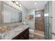 Updated bathroom featuring granite countertops, a glass-enclosed shower, and modern fixtures at 4442 Shannon Loop, The Villages, FL 32163