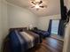 Cozy bedroom featuring a ceiling fan, neutral walls, wood-look floors, and comfortable sleeping arrangements at 4442 Shannon Loop, The Villages, FL 32163