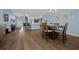 Dining area with a wooden table and chairs, adjacent to kitchen and living room at 4442 Shannon Loop, The Villages, FL 32163