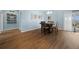 Dining area with wood-look flooring and an adjacent view of the kitchen at 4442 Shannon Loop, The Villages, FL 32163