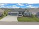 Beautiful single-Gathering home featuring a manicured lawn and three-car garage at 4442 Shannon Loop, The Villages, FL 32163