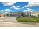 Two-story home with gray exterior and a two-car garage at 4442 Shannon Loop, The Villages, FL 32163
