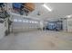 Spacious two car garage with ample room for storage and parking with high ceilings and bright lighting at 4442 Shannon Loop, The Villages, FL 32163
