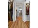 Hallway with wood-look floors and access to closets and bathroom at 4442 Shannon Loop, The Villages, FL 32163