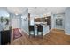 Shows eat in kitchen that features wood look floors, granite countertops, and stainless appliances at 4442 Shannon Loop, The Villages, FL 32163