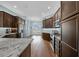 Modern kitchen with dark wood cabinets and granite countertops at 4442 Shannon Loop, The Villages, FL 32163