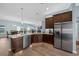 Island kitchen with stainless steel appliances and granite countertops at 4442 Shannon Loop, The Villages, FL 32163