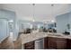 Kitchen features granite countertops, dark brown cabinets, and stainless steel appliances at 4442 Shannon Loop, The Villages, FL 32163