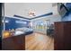 Shows bright main bedroom with blue accent wall and multiple windows with outdoor views at 4442 Shannon Loop, The Villages, FL 32163