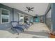 Relaxing covered patio area with ceiling fans and ample seating, perfect for outdoor lounging and entertaining at 4442 Shannon Loop, The Villages, FL 32163
