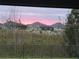 Picturesque view of vibrant sunset over neighborhood homes from backyard at 4442 Shannon Loop, The Villages, FL 32163