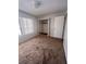 Carpeted bedroom with mirrored closet doors and a window at 452 Market E Sq, Lakeland, FL 33813