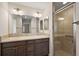 Bathroom with double sinks, ample counter space, and a glass-enclosed shower at 507 Delfin Rd, The Villages, FL 32163