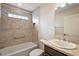Well-lit bathroom featuring a tiled shower and tub, updated vanity and neutral paint at 507 Delfin Rd, The Villages, FL 32163