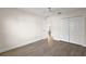 This bedroom features neutral walls, wood-look floors, closet, and ceiling fan at 507 Delfin Rd, The Villages, FL 32163