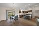 Dining area featuring hardwood floors, modern chandelier, and sliding door to the exterior at 507 Delfin Rd, The Villages, FL 32163