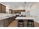 Bright kitchen with stainless steel appliances, breakfast bar, and sleek dark wood cabinets at 507 Delfin Rd, The Villages, FL 32163