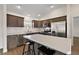 Kitchen with stainless steel appliances, breakfast bar and dark wood cabinets and flooring at 507 Delfin Rd, The Villages, FL 32163