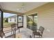 Cozy screened patio featuring seating and a ceiling fan for outdoor comfort at 507 Delfin Rd, The Villages, FL 32163