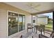 Relaxing screened-in patio with ceiling fan and sliding glass door access at 507 Delfin Rd, The Villages, FL 32163