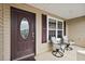 Cozy front porch features neutral furnishings and decorative glass front door at 507 Delfin Rd, The Villages, FL 32163
