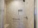 Shower stall with grab bar, niche, and tile surround at 507 Delfin Rd, The Villages, FL 32163